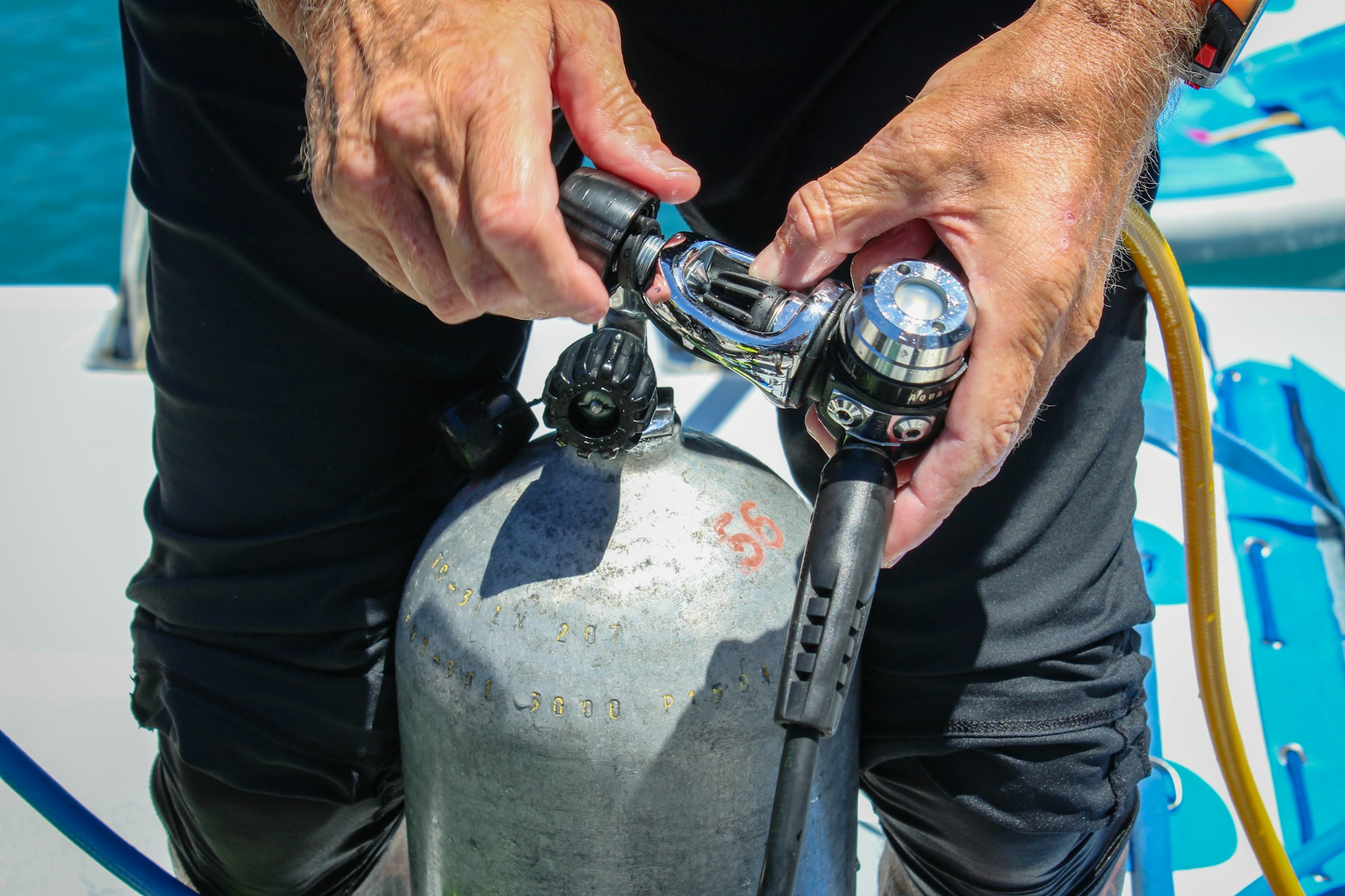 Man verifying air tank for scuba diving.