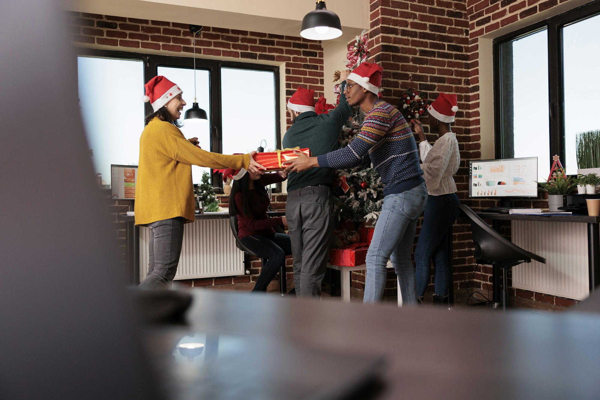 Multiethnic group of people exchanging holiday gifts