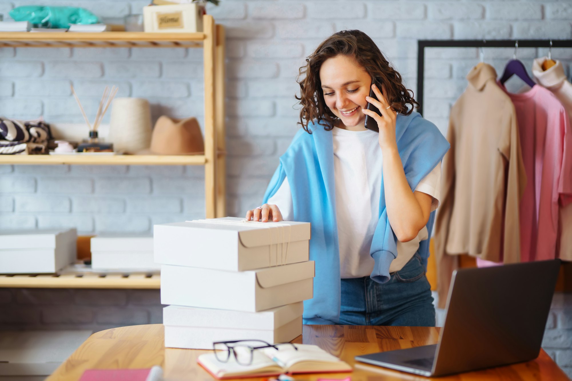 Small business owner, entrepreneur, seller using tablet checking ecommerce clothing store orders.